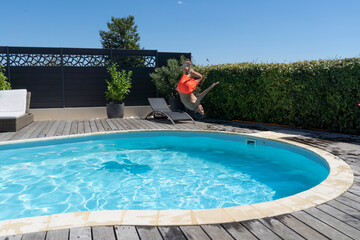 teenager jumping in the swimming pool