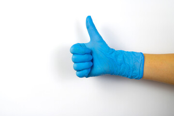 Like sign with a hand in a blue medical glove.