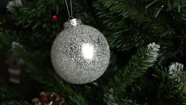 New Year's toy ball hangs on the Christmas tree