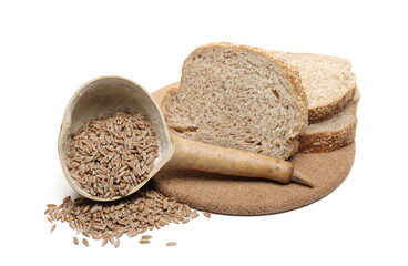 Integral wheat rye bread slices with seeds, spelt grain and gourd spoon on cork mat isolated on white background
