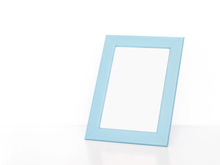 Blank light blue photo frame on white table. Interior decor mock up