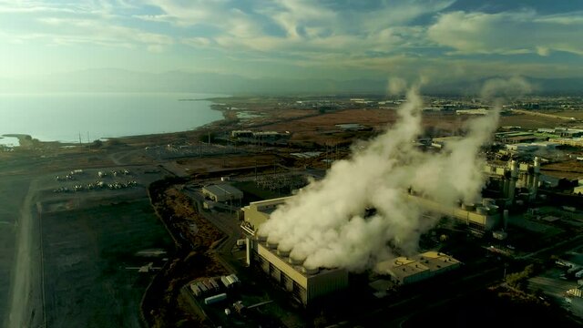 Power Station Aerial view, a natural gas turbine  Vineyard, Lehi, Utah, United States. It was built by Lake Side Power LLC from helicopter lot's of vaporous smog pouring out, sun set, day time