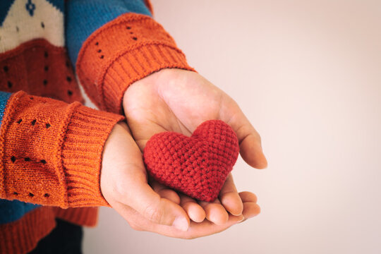 Women Wear Knit Shirt Hand Holding Red Heart. Concept Of Love, Hope, Happy Valentine, Healthcare,organ Donation,insurance, Medical, World Heart Day, National Organ Donor Day,World Mental Health Day.