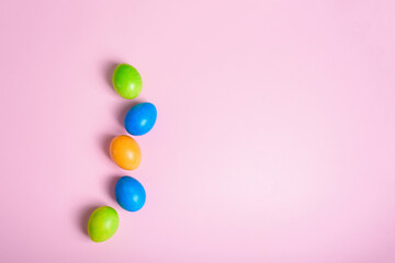 easter holiday colorful painted eggs on a pastel pink background. composition easter