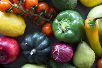 Fresh organic fruits and vegetables on a table. Healthy eating concept. Vegetarian meal ingredients top view photo. 