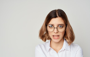 Beautiful woman wearing glasses short hair white shirt and beige background