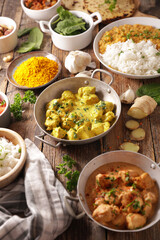 indian food selection- curry meal, chicken, pita bread