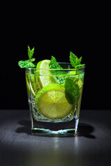 Carbonated drink or cocktail with lime, ice, and mint.