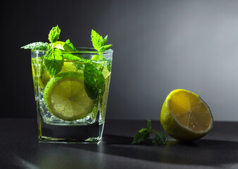 Carbonated drink or cocktail with lime, ice, and mint.