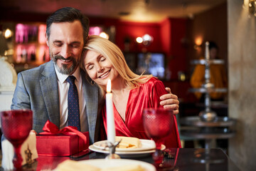 Calm blonde woman enjoying date with her beloved man