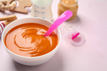 Healthy baby food in bowl on light table