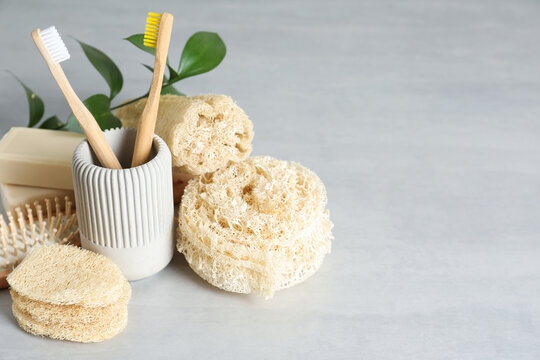 Composition with natural loofah sponges on table. Space for text