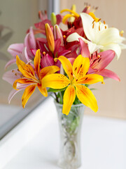 A bouquet of lilies in a vase in daylight