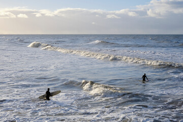 Surfers go into the sea