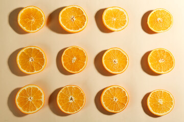 Slices of delicious oranges on beige background, flat lay
