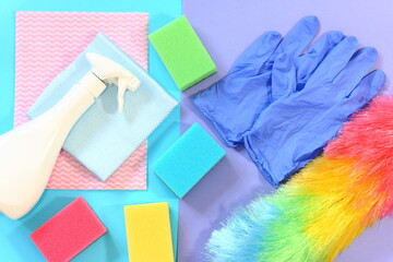 Cleaning products on blue floor. Home cleaning concept. Flat lay, top view.