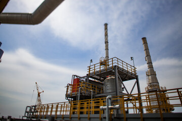 Oil refinery complex columns, towers, tank and pipelines. Tilt-shift view.