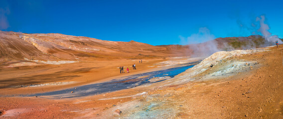 Panoramic view over colorful geothermal active zone Hverir near Myvatn lake in Iceland, resembling Martian red planet landscape, at summer and blue sky