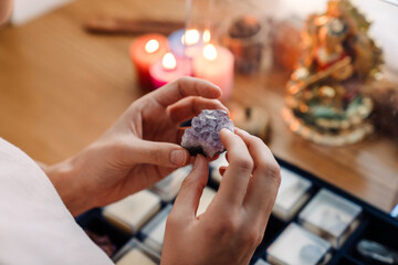 Caucasian girl examining minerals and stones set at home shrine