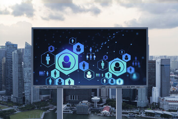 Glowing Social media icons on billboard over sunset panoramic city view of Singapore. The concept of networking and establishing new connections between people and businesses in Southeast Asia