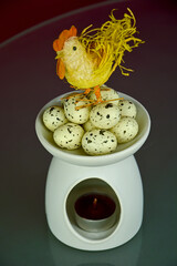 Eggs in ceramic nest and easter hen.