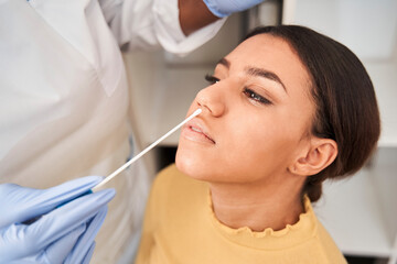 Worker with protective equipment performs coronavirus swab
