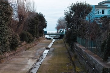 An open sewer channel in an underground area of ​​the city (Pesaro, Italy, Europe)