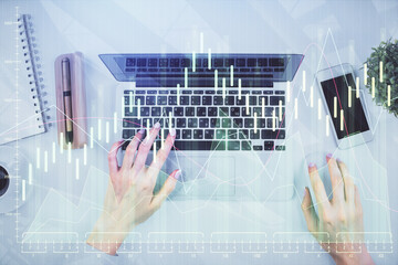 Double exposure of woman hands working on computer and forex chart hologram drawing. Top View. Financial analysis concept.