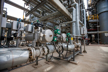 Oil refinery plant. Close up of equipment. Pipes on background.