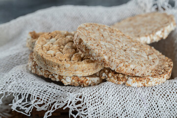 Many dietary airy crispbread on white burlap