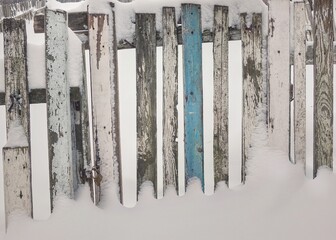 Old wooden fence in the snow
