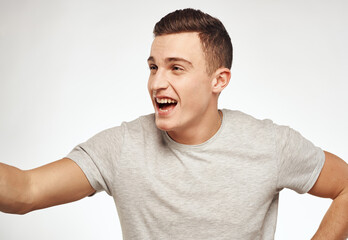 Cute man in t-shirt emotions Studio fun cropped view