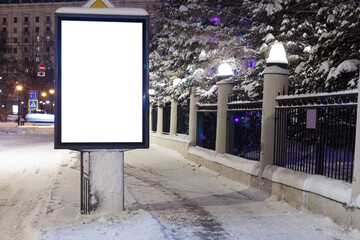 Vertical blank billboard in winter at the old hedge. Mock-up.