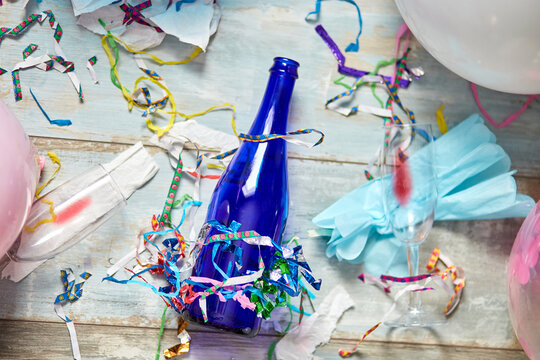 Top View Of Floor With After A Party Celebration With Empty Blue Bottles, Wine Glass And Party Decorations, Messy Living Room Interior, After Party Chaos, Birthday