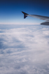 Fototapeta premium Top view from inside window airplane of blue sky and wing