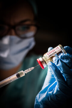 Female doctor holding a COVID-19 vaccine