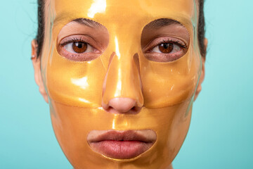 Beautiful woman using facial collagen gel skincare mask treatment