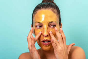 Beautiful woman using facial collagen gel skincare mask treatment