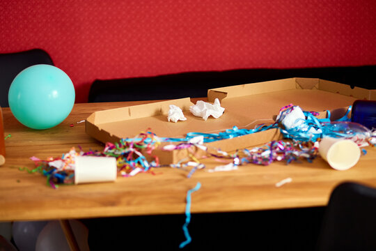Messy wooden table at morning after party.