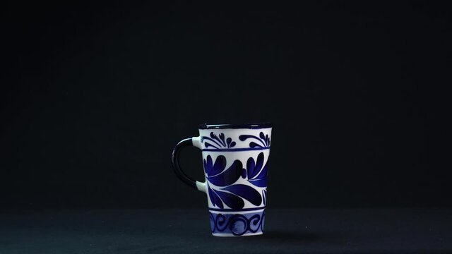 cup of talavera on elegant black background