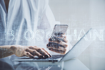 Double exposure of blockchain business sketch hologram and woman holding and using a mobile device.