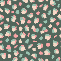 Multicolored and random placed abstract vector leo animal seamless pattern with green background. © MoJX.Studio