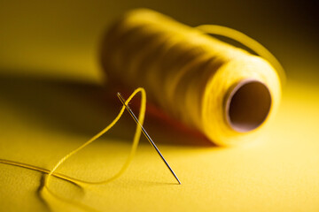 yellow thread in a needle