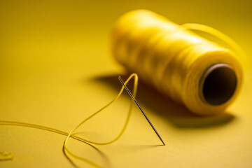 yellow thread in a needle