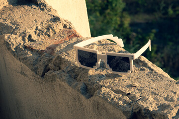Green pixel sunglasses with black lenses closeup in a sunny day. Selective focus. High quality photo