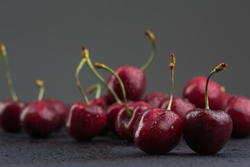 Red sweet cherry on black background
