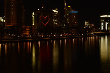 lights reflected on the river heart shape solidarity during Covid pandemic