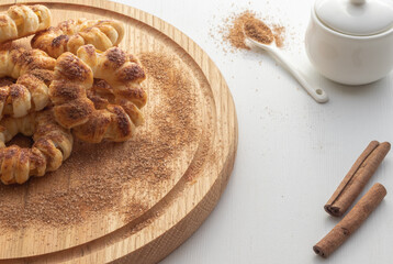 Fototapeta premium Tasty fresh baked cookies on wooden plate. Close up view. Cooking concept.