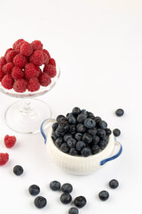 Raspberry and blue berry on white background in studio