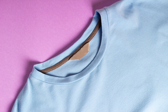 Blue Blank T-shirt With Blank Clothing Tag, Label Blank Mockup Template On A Pink Background